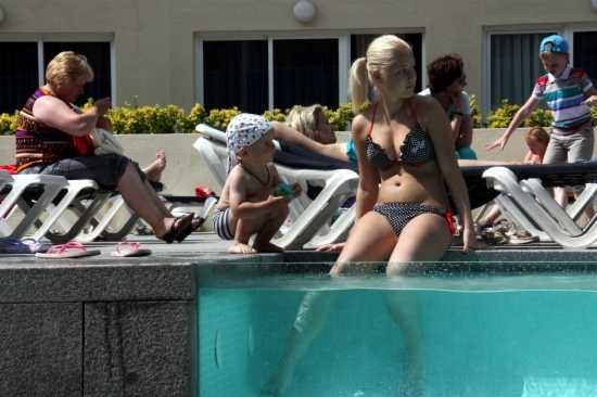 Turistes estrangers banyant-se en una piscina d'un hotel a començaments de juliol.