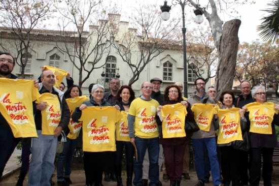Representants d'Escola Valenciana i de partits polítics i entitats que donen suport a l'entitat posen amb la samarreta de les Trobades d'escoles en valencià d'enguany.