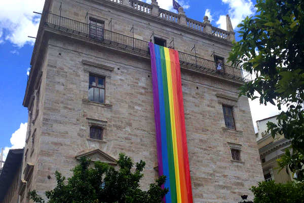 Façana del Palau amb una bandera amb l'arc de sant martí per sumarse al día internacional de l'orgull LGTBI.