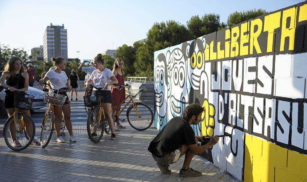 L'artista Elías Taño, pintant a València un mural dedicat als joves d'Altsasu i a 'tots els presos polítics'. / DANIEL GARCÍA-SALA